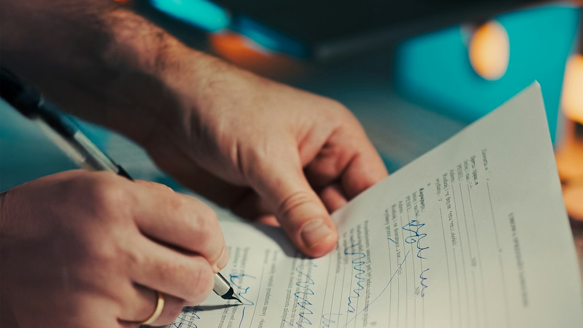 A man signing a document