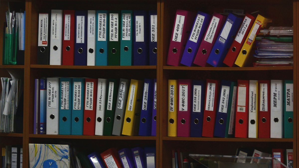 Rows of ring binders on office shelves