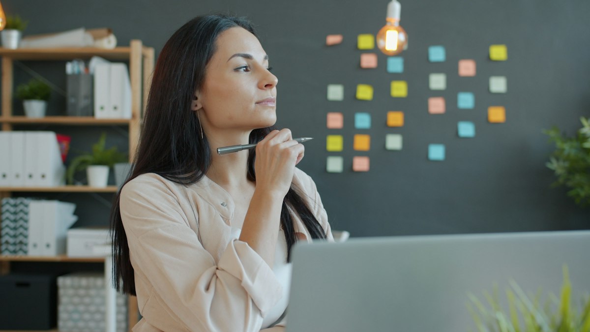 A business owner thinking at her desk