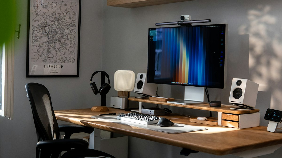A home office desk with a computer and plants