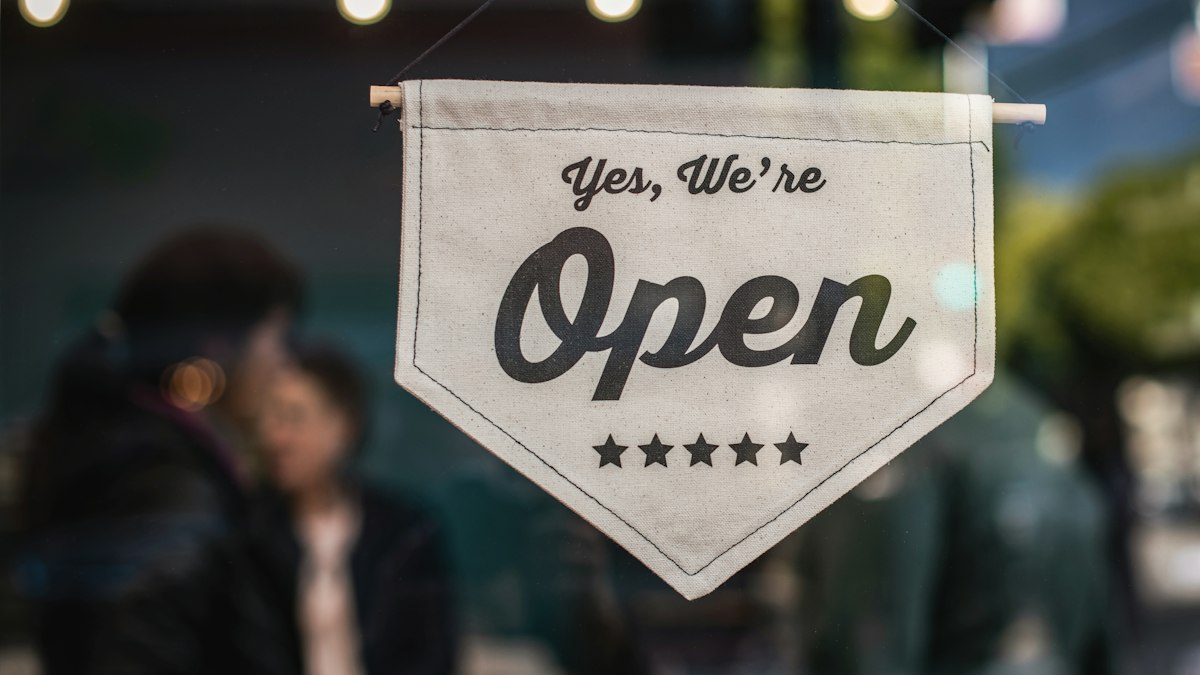 An 'Open' sign in a shop window