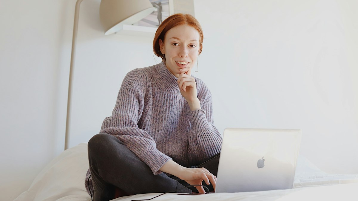 A woman working remotely on a laptop