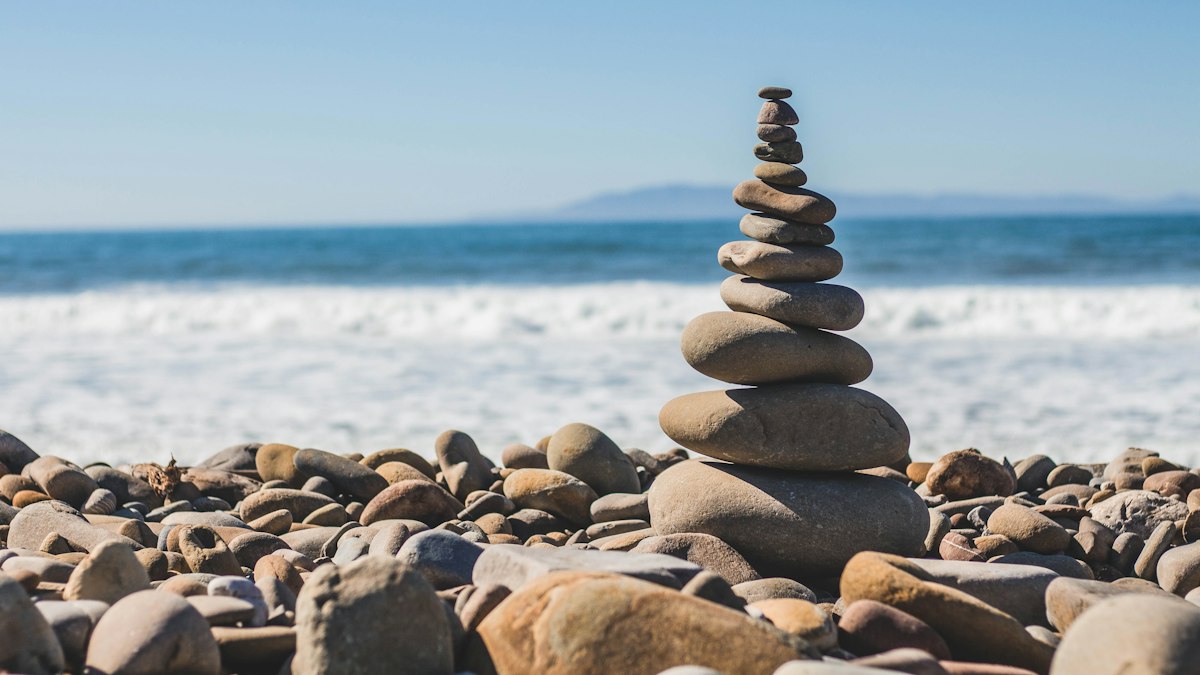 Balanced stacked stones on a beach