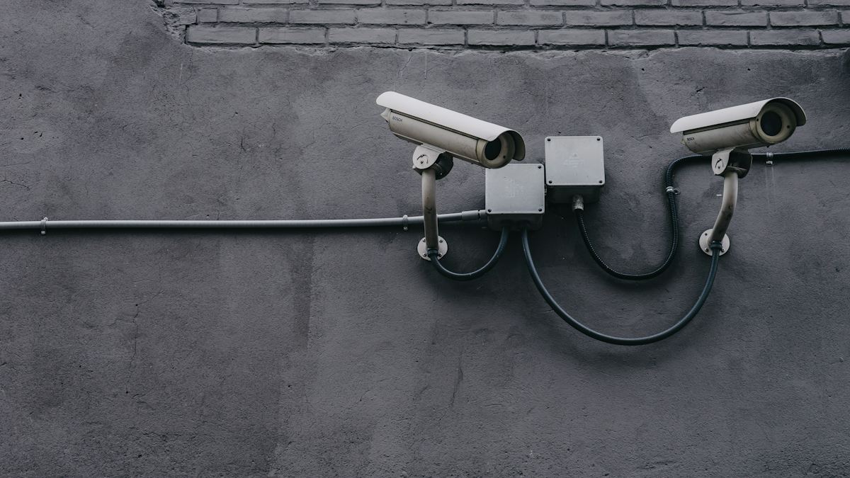 Two security cameras on a wall