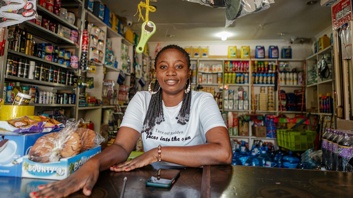 A shop owner at the counter of her store