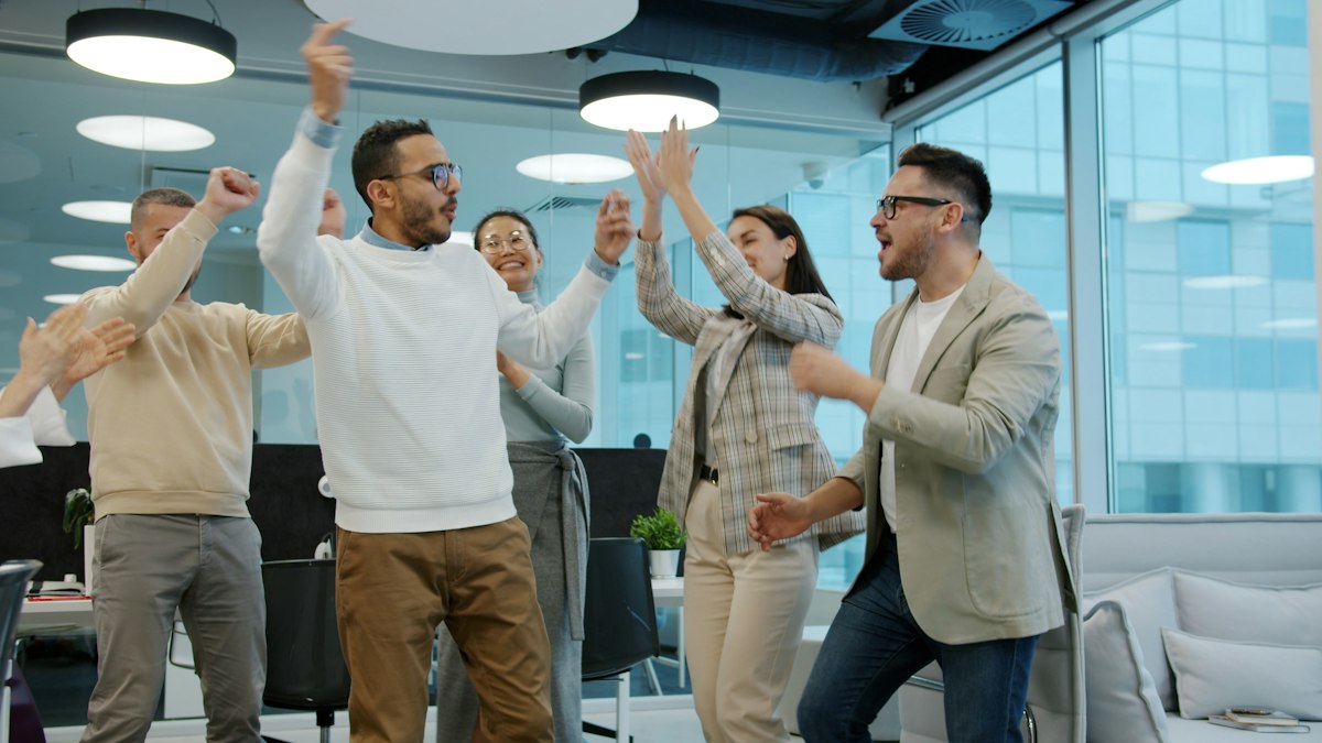 Colleagues celebrating a success in the office
